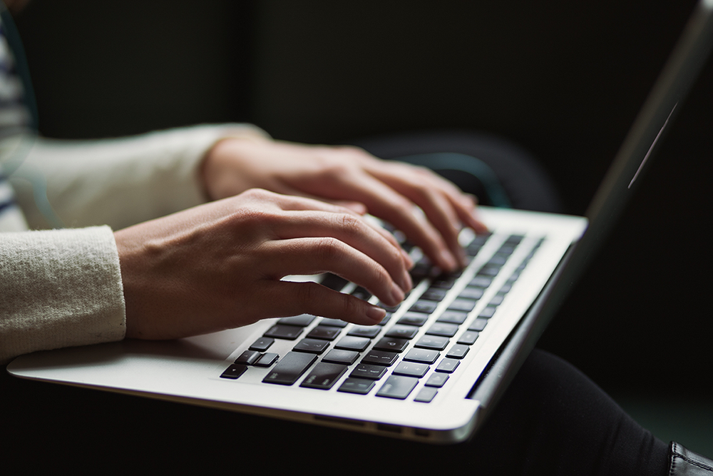 Woman using a laptop to script a market research survey